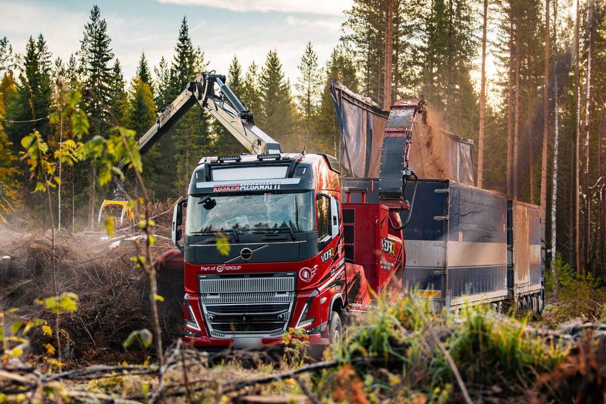 VORQ Q7.1 hakettaa hakkuutähdettä kuorma-auton kyytiin metsätiellä.